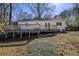 Backyard with a spacious deck, mature trees, and ample green space for outdoor activities and relaxation at 2274 Brengare Dr, Decatur, GA 30033