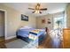 Cozy bedroom with hardwood floors, ceiling fan, and a dresser next to the window at 2274 Brengare Dr, Decatur, GA 30033