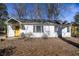 Inviting home featuring a yellow door, well-manicured front yard, and lots of curb appeal at 2274 Brengare Dr, Decatur, GA 30033