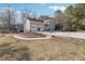 Charming front exterior with an attached two-car garage, circular driveway, and inviting curb appeal at 957 Ross Ct, Stone Mountain, GA 30087