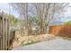 Fenced backyard with a paver patio area surrounded by lush landscaping and mature trees for privacy at 32 Hampton Dr, Cartersville, GA 30121