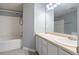 Bathroom with dual sinks, white cabinets, and a tub and shower combination with white tile at 32 Hampton Dr, Cartersville, GA 30121
