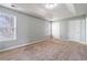 Bright bedroom with soft carpeting, white trim, and natural light from the windows at 32 Hampton Dr, Cartersville, GA 30121