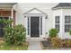 A beautiful entryway with a black door, manicured plants, and a clean walkway at 32 Hampton Dr, Cartersville, GA 30121