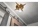 Close-up of a stylish barn door with custom track and starburst ceiling light at 694 Argonne Ne Ave # 4, Atlanta, GA 30308