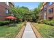 Beautifully landscaped courtyard with manicured lawn, flowerbeds, and brick-accented walkway at 694 Argonne Ne Ave # 4, Atlanta, GA 30308