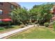 Multi-unit brick building featuring a courtyard lush green landscaping and walking paths at 694 Argonne Ne Ave # 4, Atlanta, GA 30308