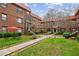 Multi-unit brick building with tile roof, lush courtyard with green grass and walkway at 694 Argonne Ne Ave # 4, Atlanta, GA 30308