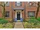 Charming brick condo with a striped awning, front door and blue chairs with red pillows at 694 Argonne Ne Ave # 4, Atlanta, GA 30308
