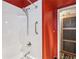 Shower in a bathroom with white tile and striking red walls at 694 Argonne Ne Ave # 4, Atlanta, GA 30308