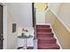 Stairwell with patterned carpet and a small decorative table with a flower arrangement at 694 Argonne Ne Ave # 4, Atlanta, GA 30308