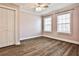 Bedroom with wood floors, crown molding, ceiling fan, and two windows at 301 Masons Creek Cir, Atlanta, GA 30350