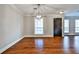 Open living area featuring hardwood floors, neutral walls, and large windows at 301 Masons Creek Cir, Atlanta, GA 30350