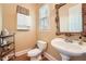 Chic half bath with a pedestal sink, ornate mirror, and stylish fixtures at 397 4Th Ne St, Atlanta, GA 30308