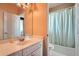 Well-lit bathroom with a tub and shower combo, single sink vanity, and neutral tones at 397 4Th Ne St, Atlanta, GA 30308