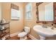 Charming powder room with a pedestal sink and decorative mirror at 397 4Th Ne St, Atlanta, GA 30308