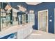 Stylish bathroom with double vanity, white cabinets, tiled floors, and a glass-enclosed shower at 397 4Th Ne St, Atlanta, GA 30308