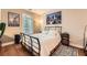 Comfortable bedroom with natural light, hardwood floors, and a black metal bed frame at 397 4Th Ne St, Atlanta, GA 30308