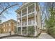 Three-story brick home showcasing multiple balconies and a serene neighborhood setting at 397 4Th Ne St, Atlanta, GA 30308