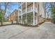 Charming home exterior with a brick facade, second story porches, and mature trees at 397 4Th Ne St, Atlanta, GA 30308