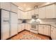 Well-maintained kitchen featuring white appliances, cabinets, and hardwood floors at 397 4Th Ne St, Atlanta, GA 30308