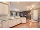 Bright kitchen featuring white cabinetry, updated appliances, and an adjacent library at 397 4Th Ne St, Atlanta, GA 30308