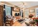 Cozy living room with wood floors, a ceiling fan, and built-in storage at 397 4Th Ne St, Atlanta, GA 30308