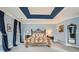 Light-filled main bedroom with tray ceiling, plush carpeting, and elegant furnishings at 397 4Th Ne St, Atlanta, GA 30308