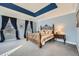 Spacious main bedroom with tray ceiling, plush carpeting, and elegant wrought iron bed frame at 397 4Th Ne St, Atlanta, GA 30308