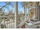 Cozy porch with white wicker furniture, pillars, and a view of the street at 397 4Th Ne St, Atlanta, GA 30308