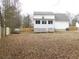 Spacious backyard featuring a wooden fence, a deck, and an old classic car, providing ample space for outdoor activities at 554 Samaritan Dr, Cumming, GA 30040