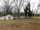 Spacious backyard features a storage shed and mature trees at 554 Samaritan Dr, Cumming, GA 30040