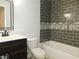 Modern bathroom features a stylish tiled shower and a dark wood vanity at 554 Samaritan Dr, Cumming, GA 30040