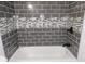 Elegant bathroom with dark gray tiled shower and mosaic tile accent at 554 Samaritan Dr, Cumming, GA 30040