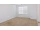 Bedroom with neutral carpeting, white walls, and a window, creating a bright and serene atmosphere at 554 Samaritan Dr, Cumming, GA 30040