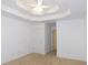 Bright bedroom featuring neutral carpeting and a tray ceiling at 554 Samaritan Dr, Cumming, GA 30040
