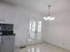 Dining area with stylish chandelier, and access to the kitchen and backyard at 554 Samaritan Dr, Cumming, GA 30040