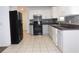 Kitchen featuring white cabinets, stainless steel appliances, and tile floors at 554 Samaritan Dr, Cumming, GA 30040