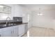 Kitchen featuring white cabinets, stainless steel appliances, and dining area at 554 Samaritan Dr, Cumming, GA 30040