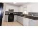 Beautiful kitchen featuring white cabinets, stainless steel appliances, and updated backsplash at 554 Samaritan Dr, Cumming, GA 30040