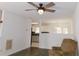 Bright living room featuring hardwood floors, a ceiling fan, and open view to the kitchen at 554 Samaritan Dr, Cumming, GA 30040