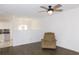 Bright living room featuring hardwood floors, a ceiling fan, and open view to the dining area at 554 Samaritan Dr, Cumming, GA 30040