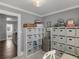 Home office space features built in shelves and is adjacent to a wood floored hallway at 2270 Emerald Dr, Jonesboro, GA 30236