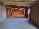 An unfinished basement with visible insulation, framing, and natural light from windows at 7402 Gossamer St, Union City, GA 30291