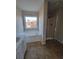Bathroom with soaking tub under a window and separate shower at 7402 Gossamer St, Union City, GA 30291