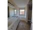 Bathroom with double sink vanity, soaking tub under a window, and separate shower at 7402 Gossamer St, Union City, GA 30291