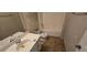 Modest bathroom with a single sink vanity and a shower-tub combo, ready for renovation at 7402 Gossamer St, Union City, GA 30291