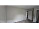 A bedroom with a neutral palette, an entry door, and a closet door, awaiting personal touches at 7402 Gossamer St, Union City, GA 30291