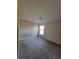 Spacious bedroom with a neutral color scheme and a window providing natural light at 7402 Gossamer St, Union City, GA 30291