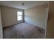 Spacious bedroom with a neutral color scheme and a window providing natural light at 7402 Gossamer St, Union City, GA 30291